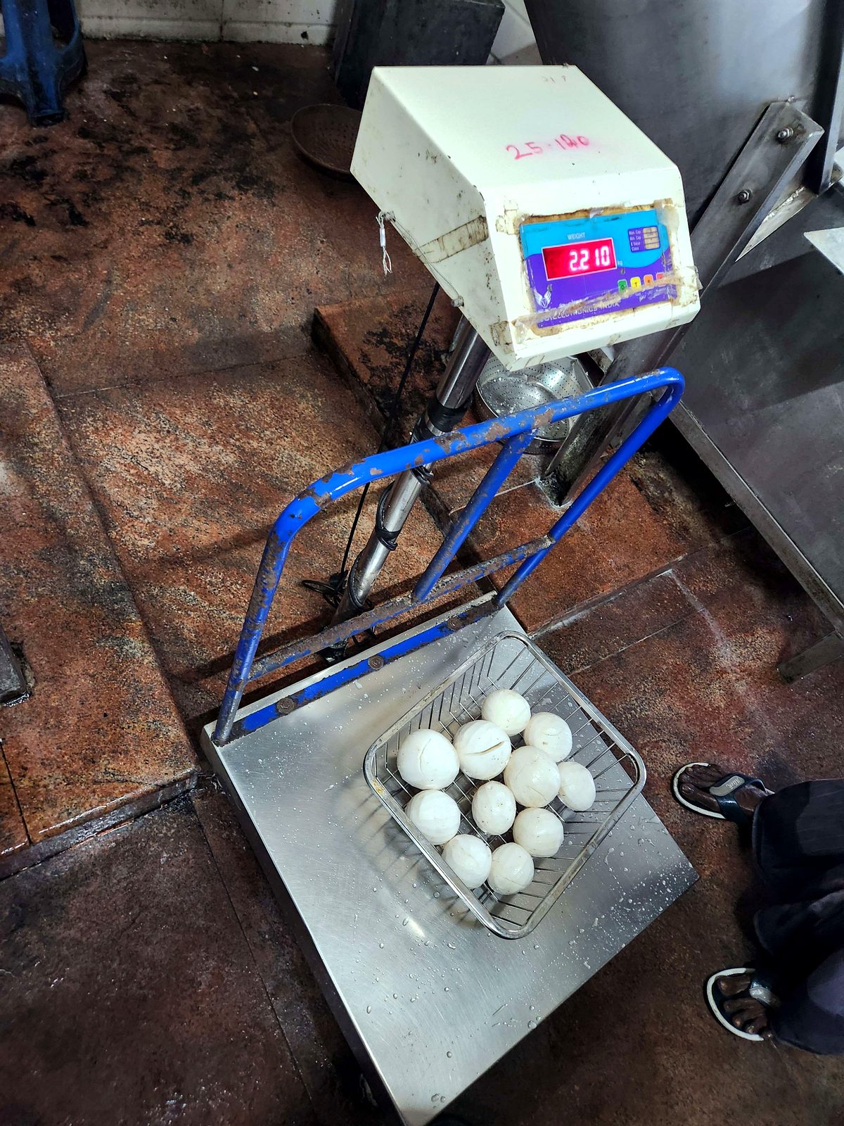 Peeled coconut kernels beside a weighing machine